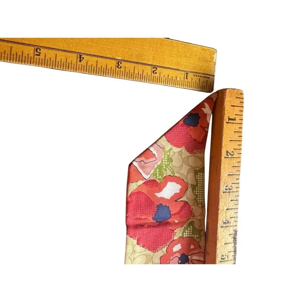 COACH silk twilly scarf orange poppy and tan signature Cs background